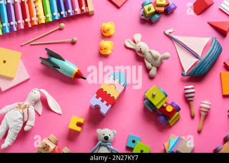 Flat lay composition with different toys on pink background Stock Photo