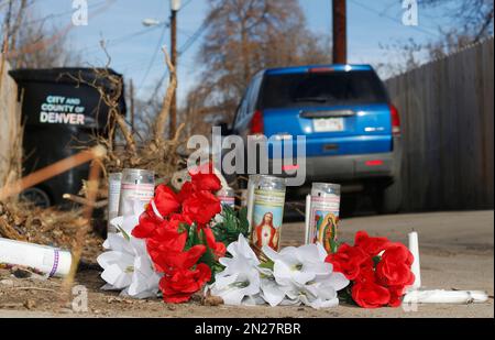 File--In this file photograph taken Tuesday, Jan. 27, 2015, a vehicle passes by the candles and bouquets left near the scene of a fatal police shooting in an alleyway in northeast Denver. A 17-year-old woman was fatally shot by police after she allegedly hit and injured an officer while driving a stolen vehicle early Monday, Jan. 26, in a northeast Denver alleyway. On Friday, June 5, 2015, Denver District Attorney Mitch Morrissey issued a statement saying that the two Denver Police officers involved in the shooting will not face criminal charges. (AP Photo/David Zalubowski, file)