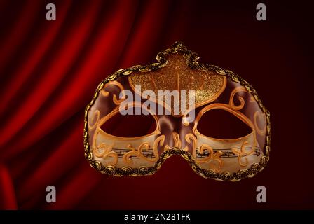 Beautiful carnival mask against red front curtain Stock Photo