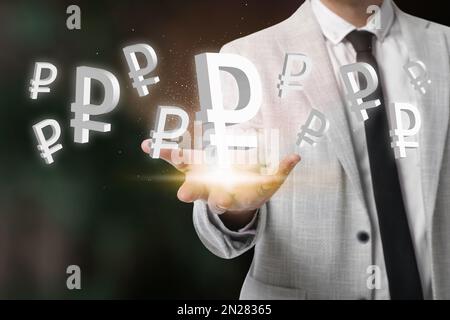Money exchange concept. Businessman with Russian ruble currency symbols on blurred background, closeup Stock Photo