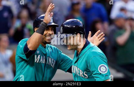 Seattle Mariners' Nelson Cruz holds his bat in the dugout during the fifth  inning of a baseball game against the Los Angeles Angels Saturday, April 8,  2017, in Anaheim, Calif. (AP Photo/Jae