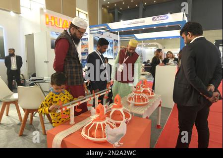 (230207) -- DHAKA, Feb. 7, 2023 (Xinhua) -- Visitors watch farm equipment at a Chinese booth during an exhibition in Dhaka, Bangladesh, Feb. 2, 2023. The '11th International Agro Tech Bangladesh-2023', South Asia's largest milling technology exhibition, was held between Feb. 2 to Feb. 4 in Bangladesh's capital city Dhaka. The exhibition was held concurrently with the three-day 'Grain Tech Bangladesh-2023' and 'Food Tech Dhaka Expo-2023', bringing together sector insiders from home and abroad, especially China, under one roof. TO GO WITH 'Feature: Chinese agricultural tech shines at Banglade Stock Photo