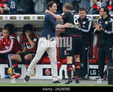 Leverkusen's head coach Roger Schmidt, center right, embraces Leverkusen's  Tin Jedvaj after the Champions League group C soccer match between Bayer 04  Leverkusen and Zenit in Leverkusen, Germany, Wednesday, Oct. 22, 2014.(AP