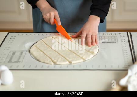 Using the kitchen silicone baking mat with markings and tips in the process of cooking in the kitchen with copy space Stock Photo