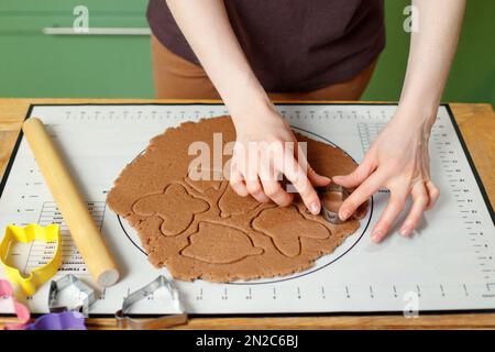 A woman prepares Easter homemade cookies on a silicone baking mat Stock Photo