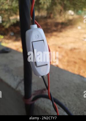 An electric switch button for single phase electric supply on an isolated background Stock Photo