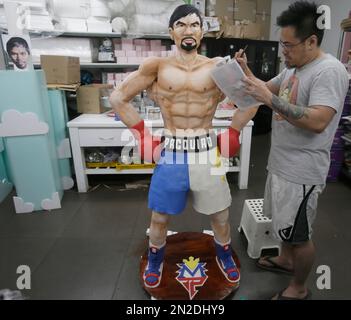 Zach Yonzon, owner of The Bunny Baker cafe, puts finishing touches on