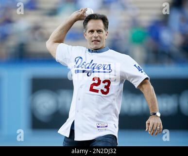 Former Los Angeles Dodgers first baseman Eric Karros smiles afterthrowing  out a ceremonial first pitch before the baseball game between the Los  Angeles Dodgers and Arizona Diamondbacks, Friday, May 1, 2015, in