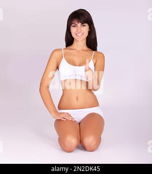 One big thumbs up for fitness. Studio portrait of a beautiful young woman giving you the thumbs up. Stock Photo