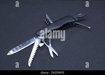 A Multitool in black background Stock Photo