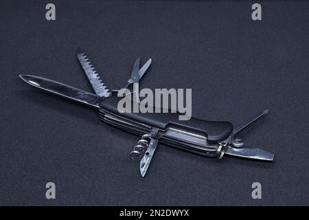 A Multitool in black background Stock Photo