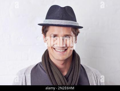 Handsome and confident. Portrait of a handsome young man wearing a trendy hat. Stock Photo