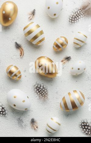 Easter eggs painted with gold paint on a concrete  background. Concept of Easter holidays. Festive background. Stock Photo