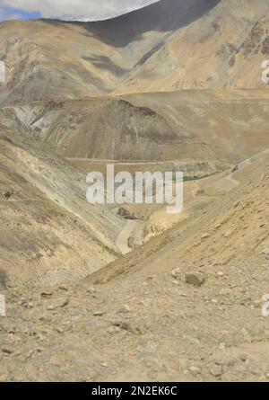 A view of confluence of the Zanskar and Indus rivers flowing through beautiful dry mountains in Nimmu Valley, Ladakh, INDIA. Stock Photo