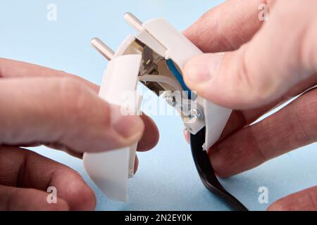 Collapsible electrical plug for power cord is designed for European standard electrical outlets. Stock Photo