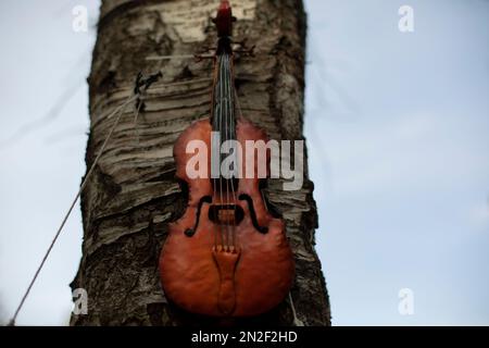 Violin on wood. Stringed musical instrument. Details of music festival. Music symbol. Stock Photo