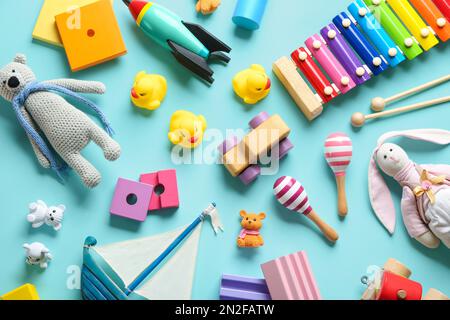 Flat lay composition with different toys on light blue background Stock Photo