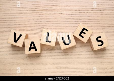 Cubes with word VALUES on wooden background, flat lay Stock Photo