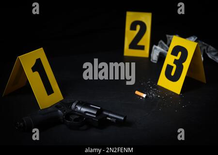 Crime scene markers and evidences on black background Stock Photo