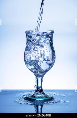 The image of pouring drinking water, into a broken glass, that makes one feel refreshed on blurred white background, Splashing water, Sparkling water, Stock Photo