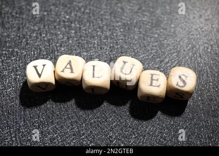Beads with word VALUES on black background, above view Stock Photo