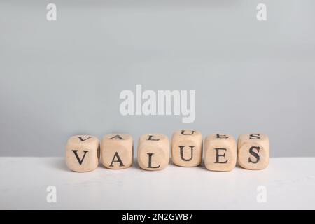 Beads with word VALUES on white table Stock Photo