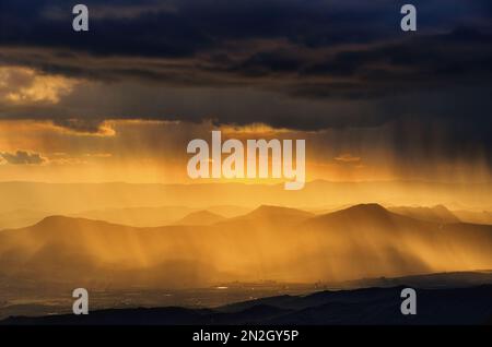 landscapes with storm clouds in the dramatic sky at the sunset over mountain range in Sicily, Italy Stock Photo