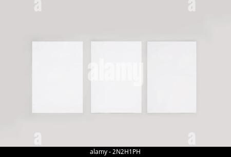 Blank posters on light wall. Mockup for design Stock Photo