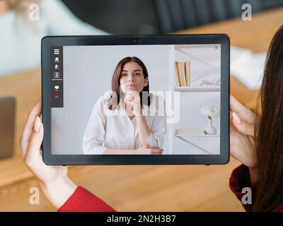 video interview female business partners on tablet Stock Photo