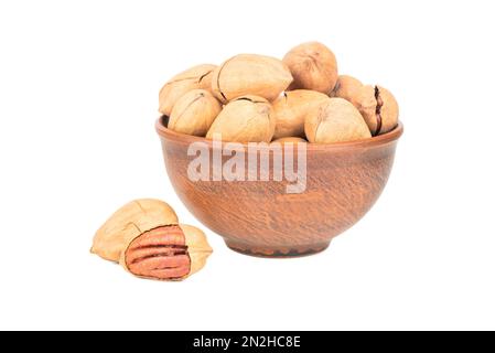 Pecan nuts in shell and bowl on white background Stock Photo