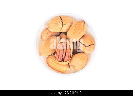 Pecan nuts in bowl on white background top view Stock Photo