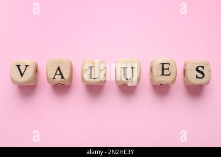 Beads with word VALUES on pink background, flat lay Stock Photo
