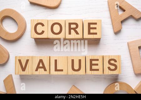 Cubes with phrase CORE VALUES on white wooden background, flat lay Stock Photo