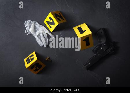 Flat lay composition with evidences and crime scene markers on black background Stock Photo