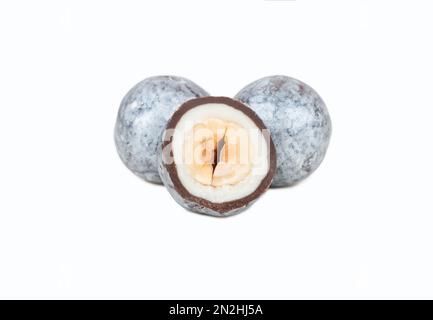 Candy hazelnuts in chocolate with cut half isolated on white background. Stock Photo