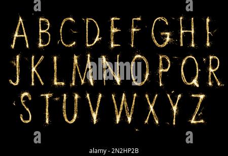 Set with letters made of sparkler on black background Stock Photo