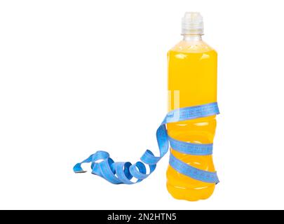 Plastic bottle with orange isotonic drink wrapped with a measuring centimeter isolated on a white background. The concept of weight loss and running. Stock Photo