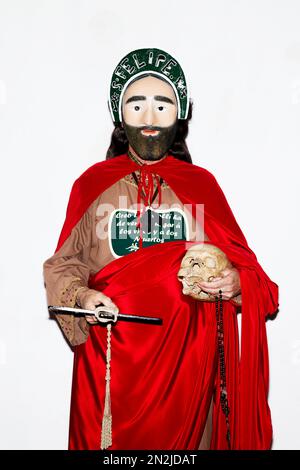 A penitent poses for a picture dressed with typical Apostle dress ...