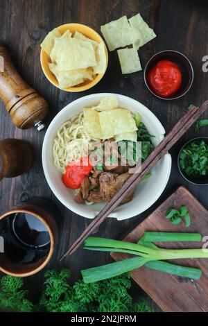 serving of chicken noodles with complementary ingredients Stock Photo