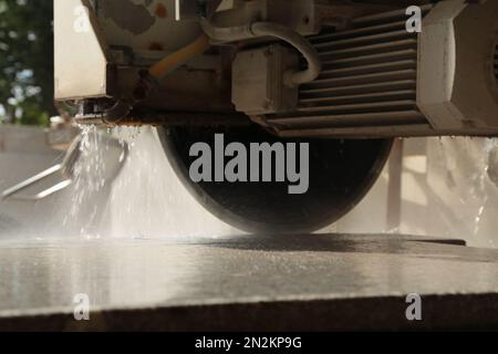 Processing of marble in the quarry. Industrial Machinery for cutting the marble block. Detail of the material being processed. Stock Photo