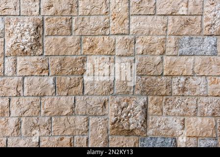 Stone tiled facade wall of a building as background Stock Photo