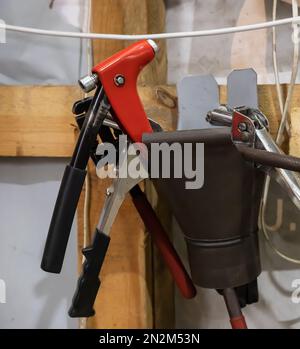 tools in the workshop drills, screwdrivers, scissors on the metal, on the shelf Stock Photo
