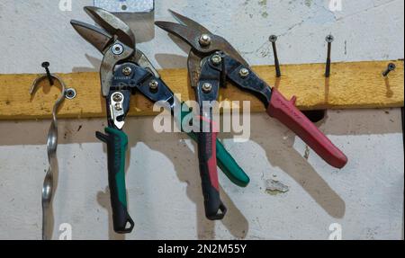 tools in the workshop drills, screwdrivers, scissors on the metal, on the shelf Stock Photo
