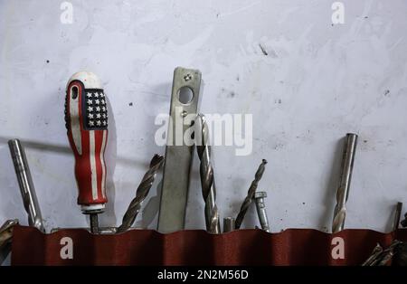 tools in the workshop drills, screwdrivers, scissors on the metal, on the shelf Stock Photo