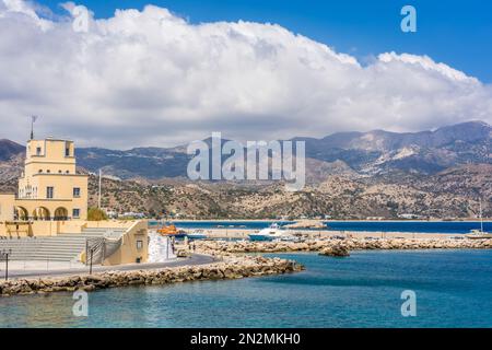 Karpathos, Greece - August 2022 : Port in Pigadia town with dramatic mountains landscape in the background Stock Photo