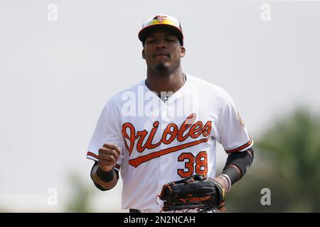 Baltimore Orioles third baseman Jimmy Paredes wipes pie from his face after  teammate Adam Jones threw a pie in his face in celebration after Paredes  hit the game winning RBI double in