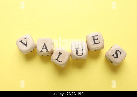 Beads with word VALUES on yellow background, flat lay Stock Photo