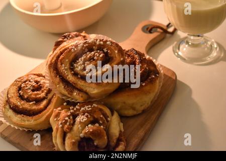 Swedish Homemade Cinnamon Rolls on a rustic Cutting board. Stock Photo