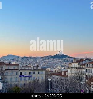 Sunrise over cityscape with Notre-Dame de la Garde in the distance, Marseille, Provence-Alpes-Cote d'Azur, France Stock Photo