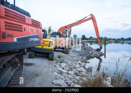 Construction machinery carrying out regulation works at the Odra river in order to adapt it to the class III waterway in Brody village. The Odra River is an important communication route, it is part of the E30 waterway connecting the Baltic Sea with the Danube in Bratislava. The E30 waterway in Poland covers the Odra River from the border with the Czech Republic to Swinoujscie, where the Swinoujscie LNG terminal is located.WWF Germany and experts from the IGB Leibniz-Institute of Freshwater Ecology and Inland Fisheries call for the cessation of works aimed at expanding the Oder riverbed and re Stock Photo